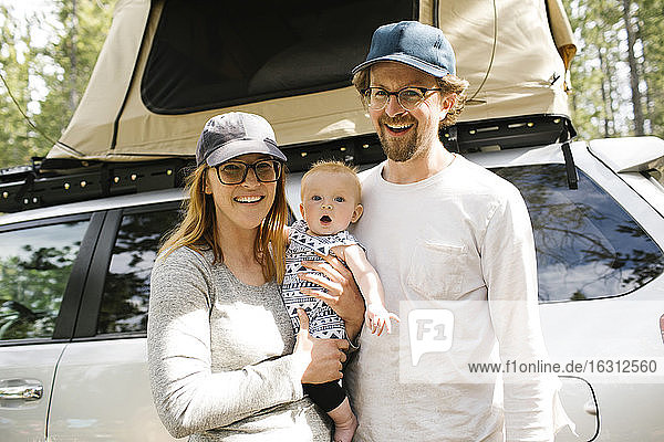 Portrait of parents with baby son (6-11 months) on camping in forest  Wasatch Cache National Forest