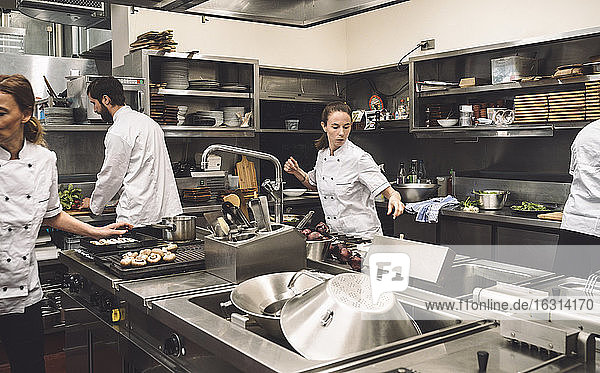 Chefs working in commercial kitchen at restaurant