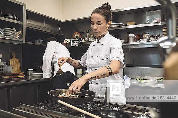 Female chef preparing food at restaurant
