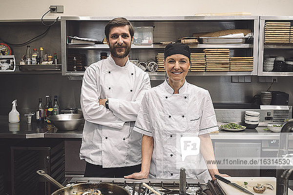 Portrait of smiling chefs in commercial kitchen