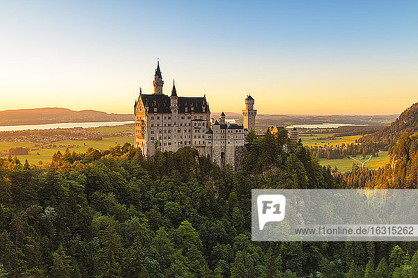 Schloss Neuschwanstein bei Sonnenuntergang  Blick auf den Forggensee  Schwangau  Allgäu  Schwaben  Bayern  Deutschland  Europa
