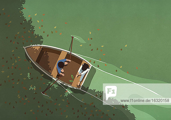 Autumn leaves falling around couple in rowboat on lake