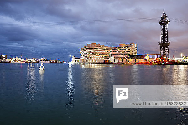 Spain Barcelona view to port at duskwith Torre Jaume I of cable car