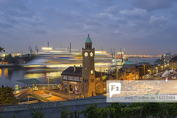 Germany  Hamburg  clocktower at Landungsbruecken and incoming cruise ship in the morning