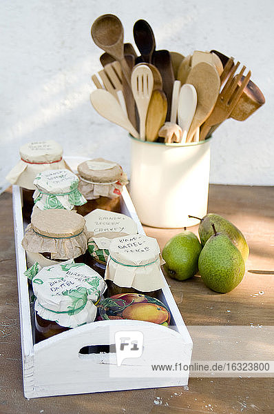 Wooden tray with preserving jars of pear chutneys