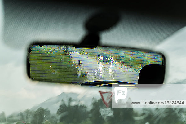 View at driving mirror by rain
