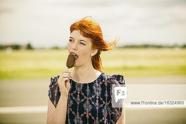 Portrait of young woman with ice lolly