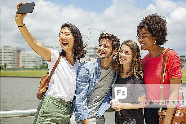 Glückliche junge Freunde machen ein Selfie mit ihrem Smartphone