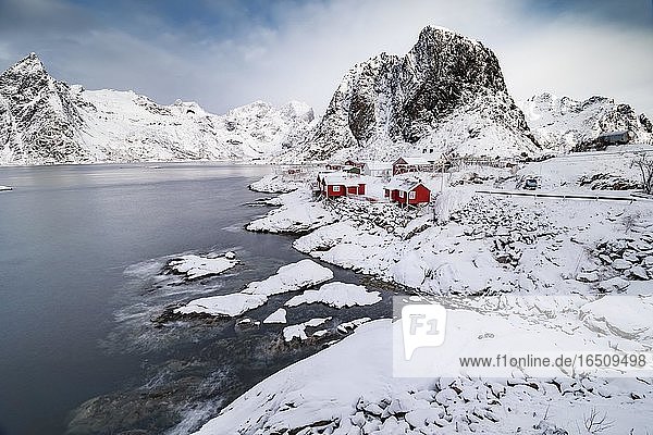 Rorbuer Fischerhütten am verschneiten Fjord  Ortsansicht Fischerdorf Hamnoy  Hamnøya  Moskenesøy  Nordland  Lofoten  Norwegen  Europa