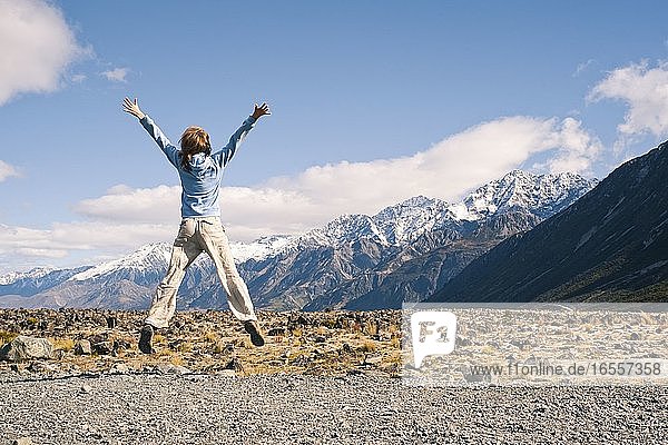 Young Woman Jumping for Joy in Aoraki Mount Cook National Park  South Island  New Zealand