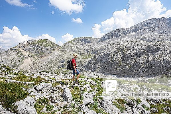 Wanderer in einer Landschaft aus ausgewaschenen Karststeinfelsen  Funtenseetauern  Steinernes Meer  Nationalpark Berchtesgaden  Berchtesgadener Land  Oberbayern  Bayern  Deutschland  Europa