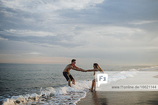 Couple enjoying while playing at beach