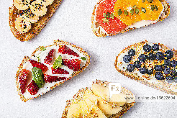 Studio shot of five slices of bread with fresh fruits