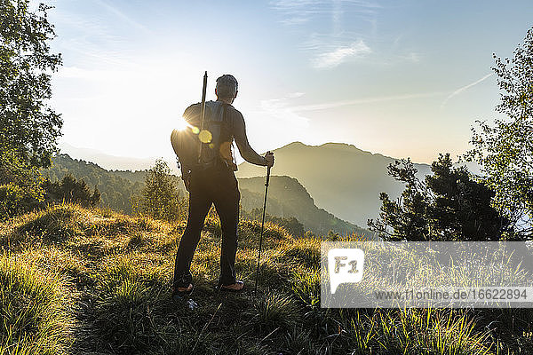 Mature man looking at mountain against sky at sunrise  Orobie  Lecco  Italy