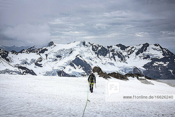 Mature man hiking on snow covered landscape against sky  Stelvio National Park  Italy