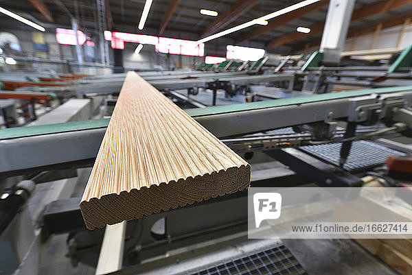 Planks being processed in lumberyard