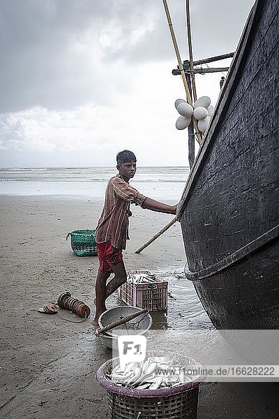 Rohingya works for fishermen on the beach of Cox Bazaar Bangladesh Asia