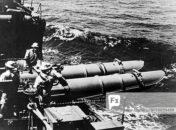 South China Seas  October  1941
A crew of Japanese torpedomen stand beside a bank of torpedo tubes aboard a destroyer in the South China Seas.