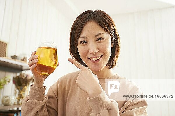 Japanese woman drinking at home remote drinking