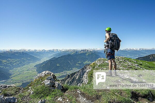 Hiker looks down into the Inn valley  Haidachstellwand peak  5-summit via ferrata  hike at the Rofan Mountains  Tyrol  Austria  Europe