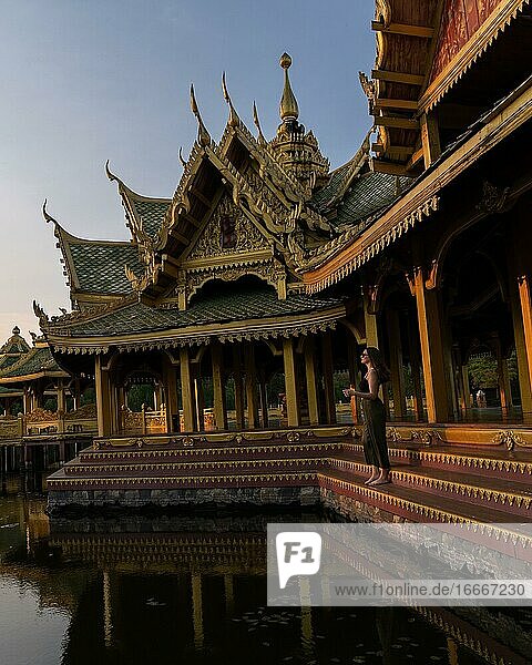 Hexagonal golden temple with standing person  Ancient City  Bangkok  Thailand  Asia