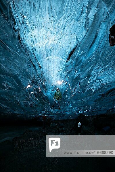 Person in an ice cave with headlamp Vatnajökull glacier Iceland Europe