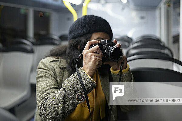 woman taking photos in a public transportation