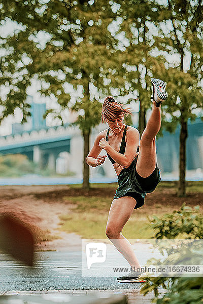 Young woman exercising outdoors in park.