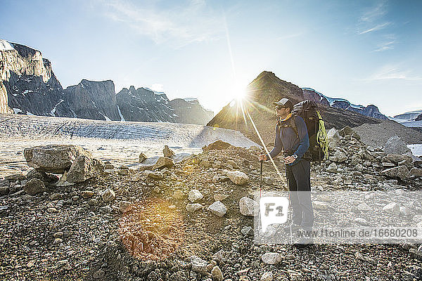 Backpacker standing on glacial moraine in Auyuittuq National Park