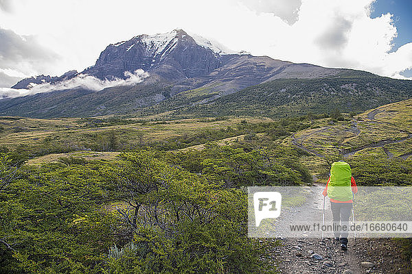 Female hiker on the way up to Torres del Paine National Park Patagonia
