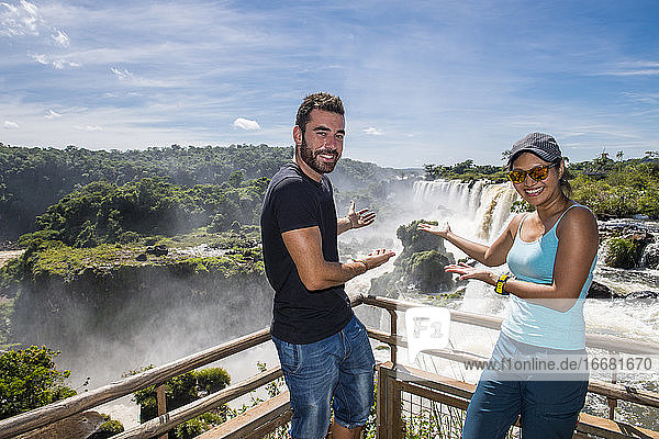 couple presenting the Iguazu waterfalls in Argentina