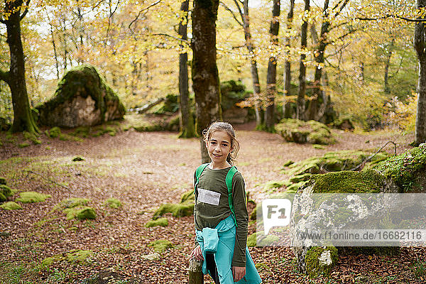 girl walking through a beech forest