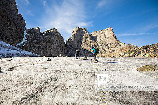 Roped climbing team approach Mount Asgard  Baffin Island.
