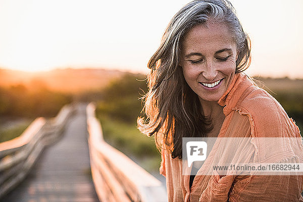 Portrait of Gray Haired Woman at the beach for sunset