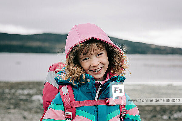close up candid portrait of young girl laughing whilst hiking