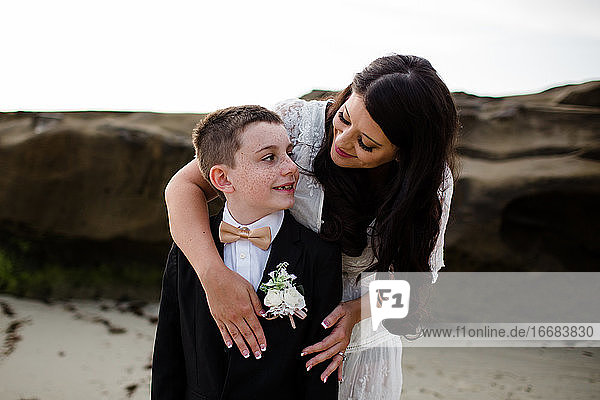 Newlywed Mother Hugging Son on Windansea Beach in San Diego