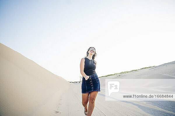 Junge Frau beim Spaziergang entlang der Dünen