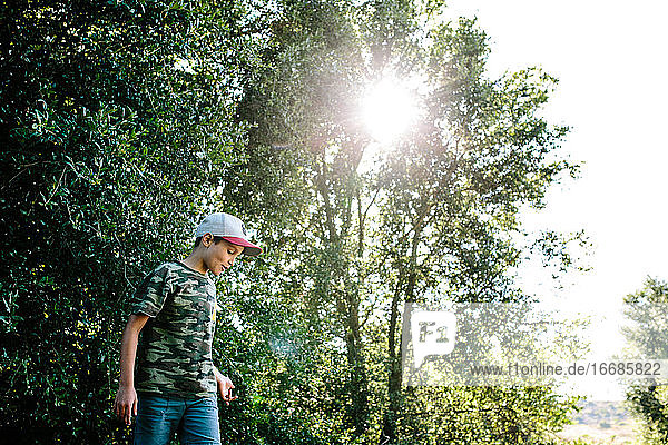 Profil eines Jungen  der ein Tarnhemd trägt  während er draußen in der Natur ist