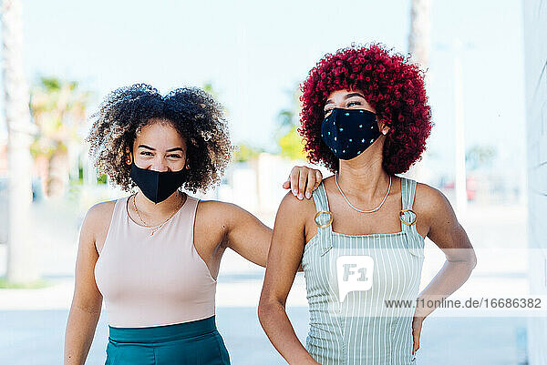 Two latin women with protection mask in a carefree attitude.