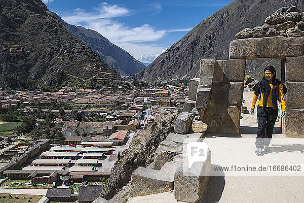 Woman exploring Inca ruins above Ollantaytambo  Peru