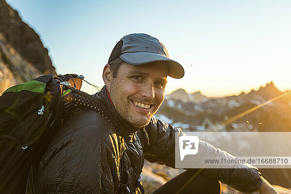 Portrait of backpacker smiling  enjoying night in the mountains.