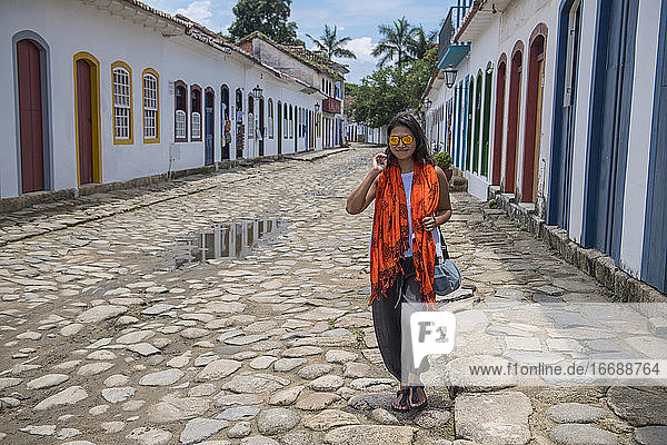 woman walking through the streets of Paraty in Brazil