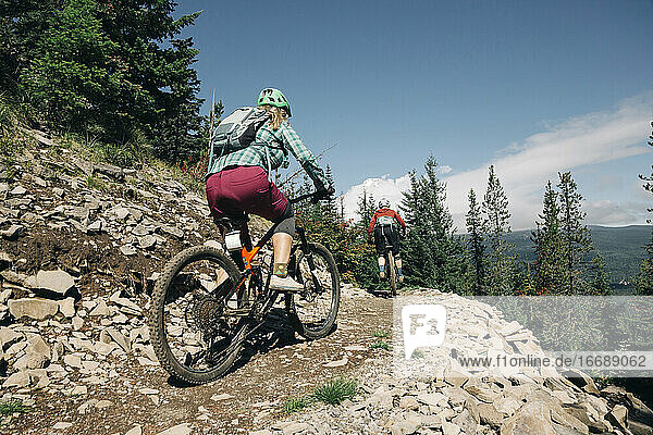 Two female bikers ride on a trail at Timberline Bike Park in Oregon.