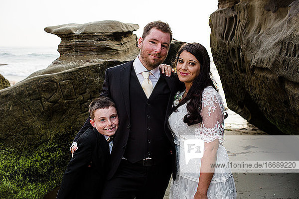 Newlyweds Posing with Nine Year Old Son on Beach in San Diego