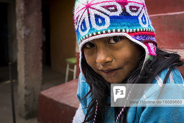 Portrait of cute girl in warm clothing  Amantani Island  Lake Titicaca  Peru