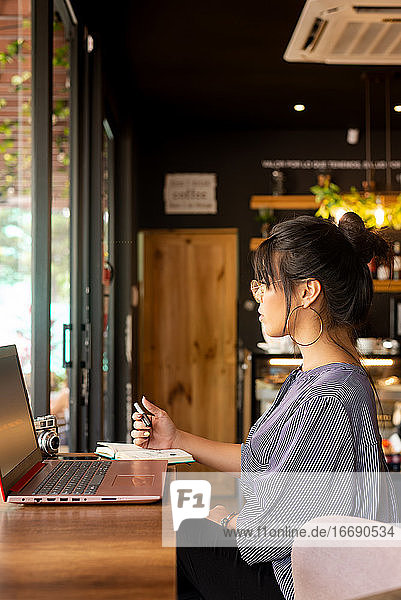 girl having coffee while working in a cozy environment