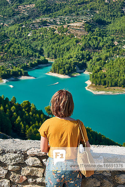 Woman looks at the Guadalest reservoir in Spain