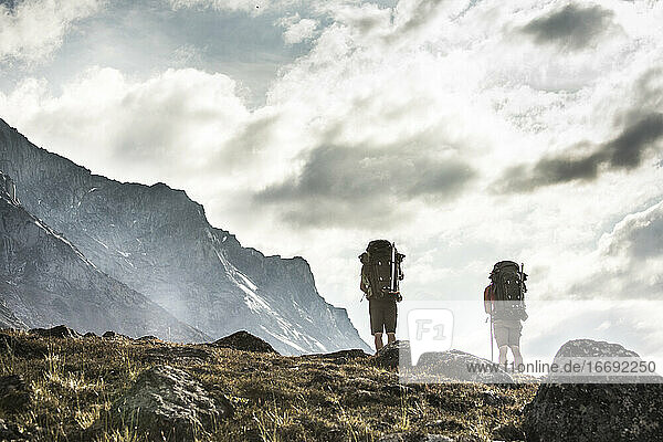 Low angle view of two backpackers on an alpine hillside