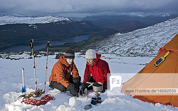 couple reading map on the side of Helvellyn mountain