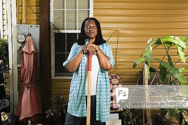 Porträt einer afroamerikanischen Frau  die vor ihrem Haus steht